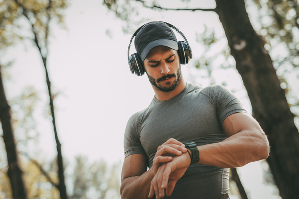 Image shows an athlete using fitness technology to help him understand what is training heart rate.