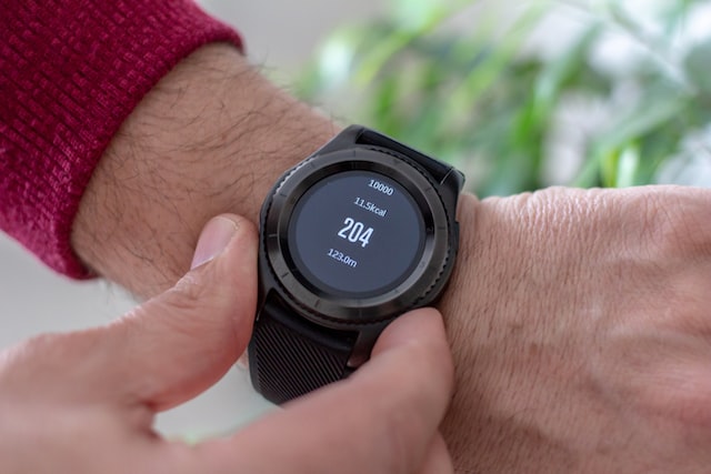 The image shows a wrist worn heart rate monitor being utilised by an athlete to track their workout intensity during exercise.